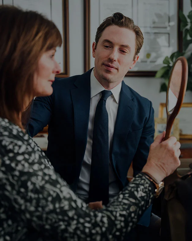 Dr. Carney showing having a patient admire their rejuvenated face